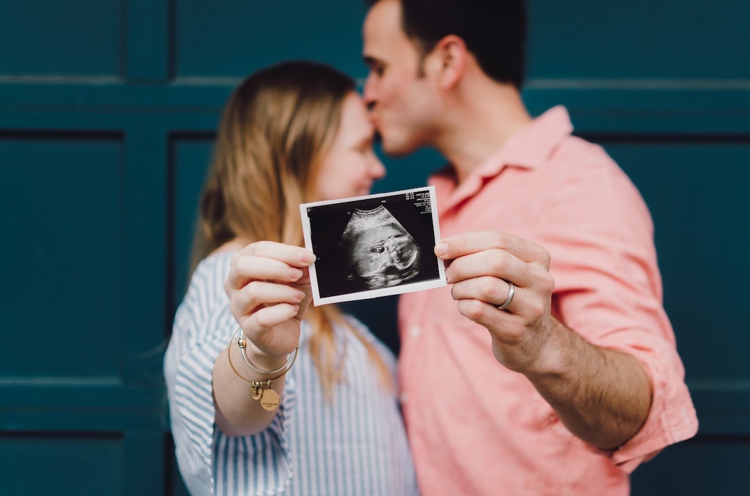 Couple holding a ultrasound photo.